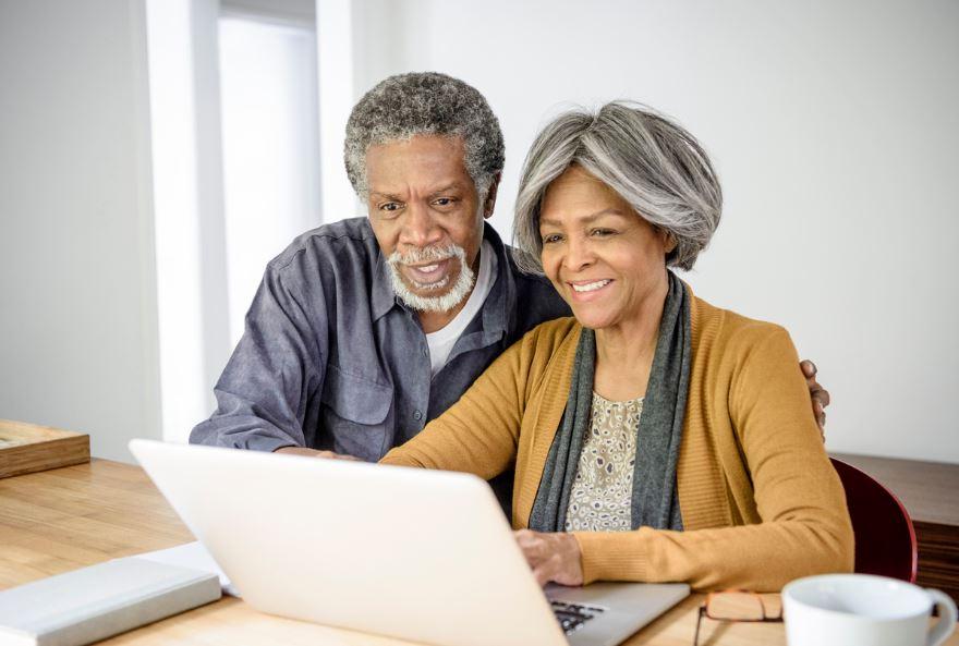 An older couple use a computer together